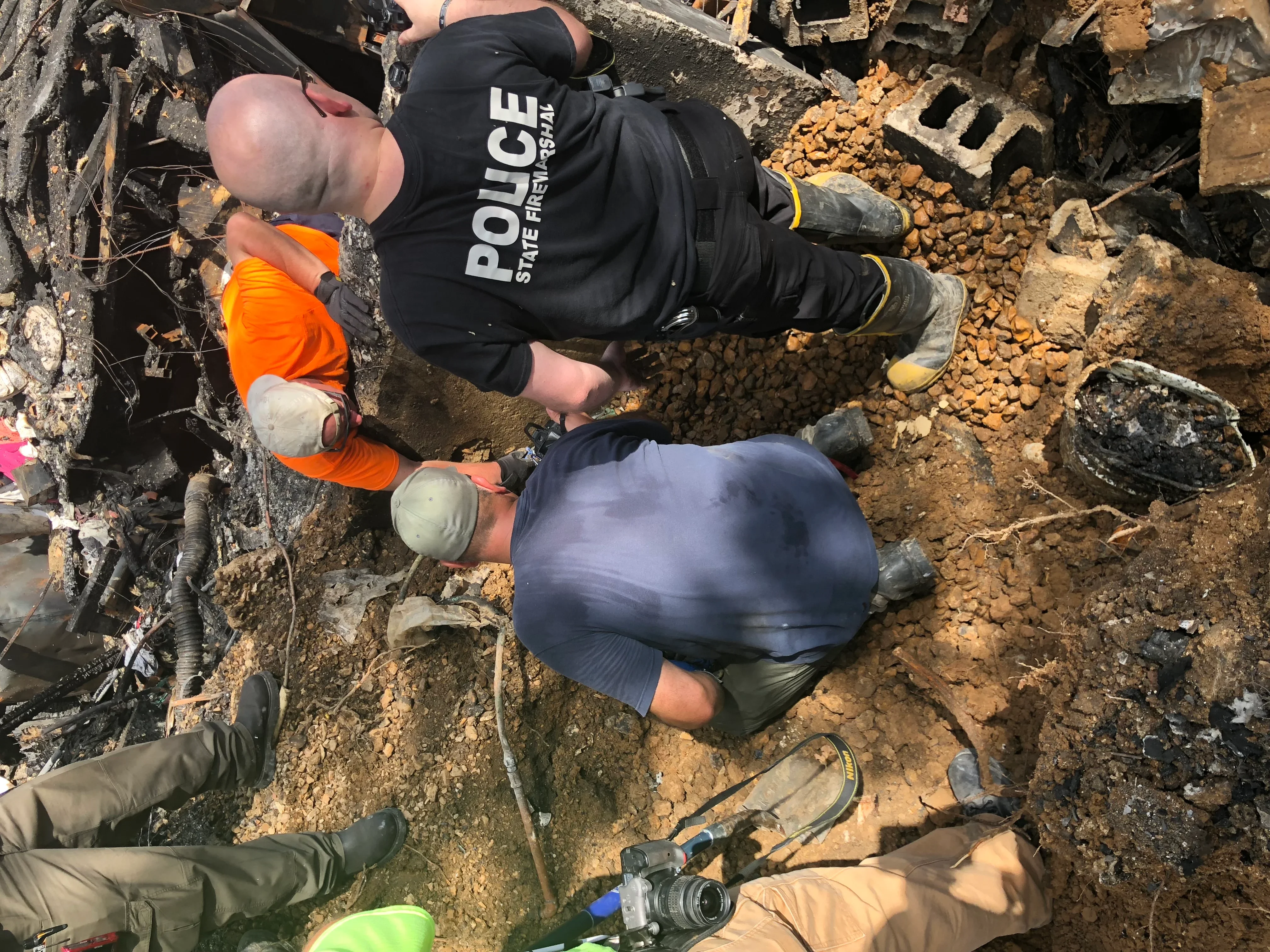 Excavation crew removing foundation debris and soil from demolition site
